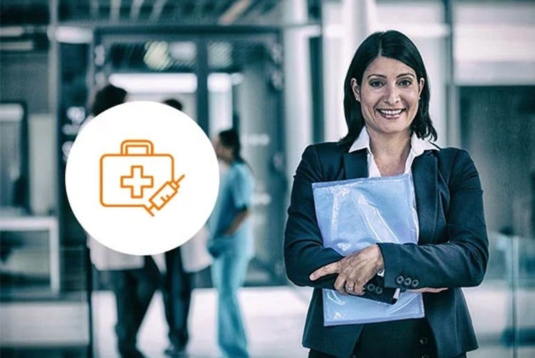 healthcare-cs-1 Professional woman in business attire holding documents, standing confidently in a healthcare setting with a medical icon overlay, symbolizing the intersection of business and healthcare management