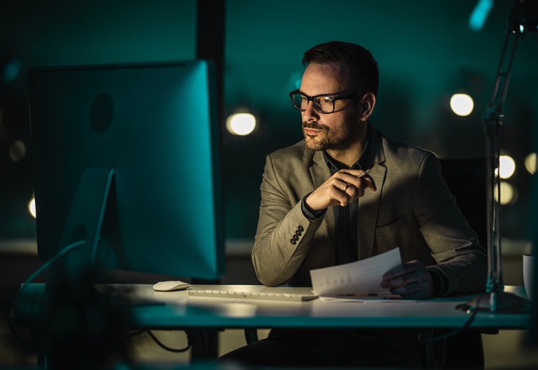 Man dark office computer